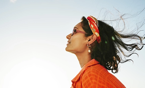 Young woman with a blue sky background